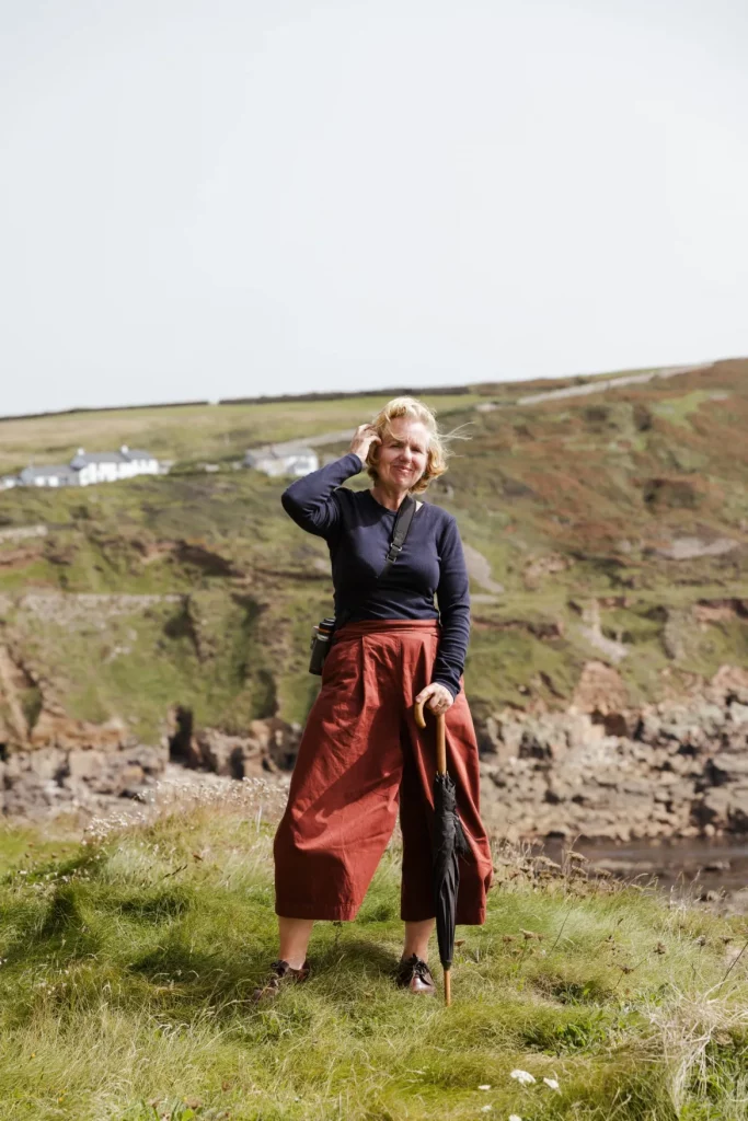 Photo of Angela standing on cliff edge