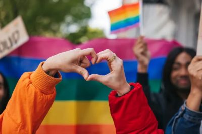 picture of pride flag and hands in heart shape