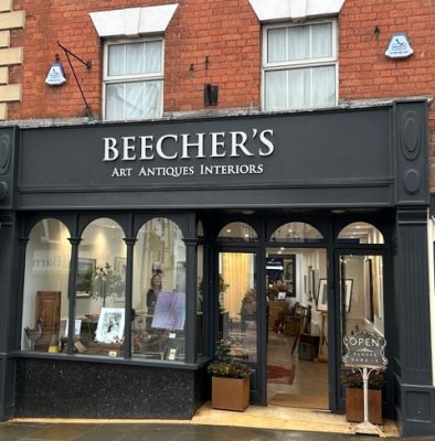 Picture of shopfront painted balack and 'Beecher's' in white