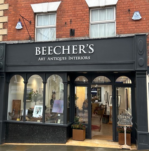 Picture of shopfront painted balack and 'Beecher's' in white